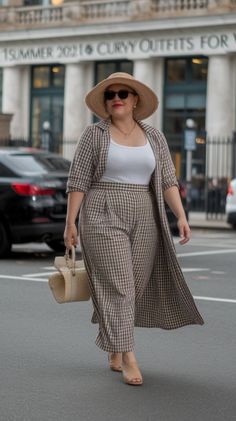 Woman in a plaid outfit and straw hat walking on a city street