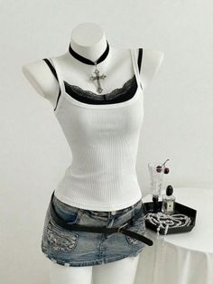 Mannequin wearing a white tank top, denim mini skirt, and cross necklace