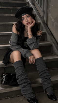 Woman in a black beret and leg warmers sitting on stairs