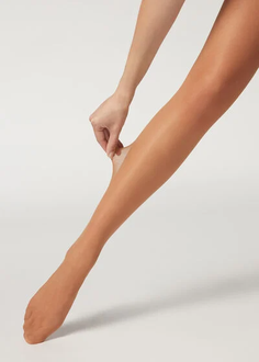 Hand pulling sheer nude tights on a leg against a white background