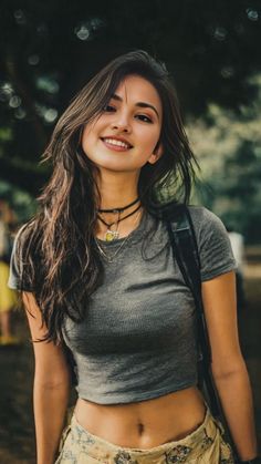 Smiling woman in a crop top and choker outdoors