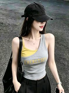 Woman in a black cap and tank top with long hair outdoors