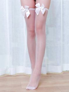 Person wearing white thigh-high stockings with bows