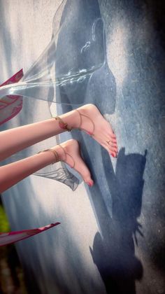 Bare feet with red nail polish and anklets on a textured surface