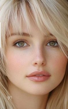 Close up portrait of a woman with blonde hair and green eyes