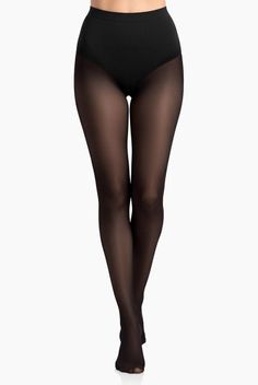 Woman wearing black tights and underwear against a white background