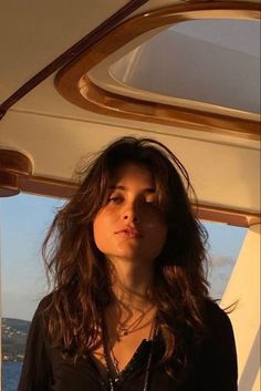 Woman with long hair on a boat during golden hour