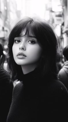 Woman with short black hair and a turtleneck in a black and white portrait