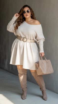 Woman in an off-shoulder dress, thigh-high boots, and sunglasses holding a handbag