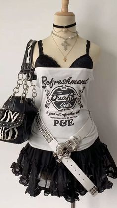 Gothic fashion outfit displayed on a mannequin with a studded belt and layered necklaces