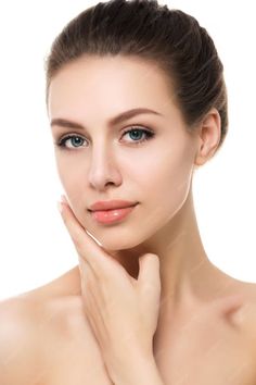 Woman with brown hair and blue eyes, hand touching her chin, on a white background