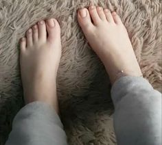 Bare feet with an anklet on a soft, shaggy rug
