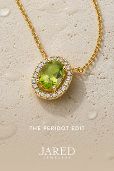 Gold necklace with an oval peridot pendant surrounded by diamonds