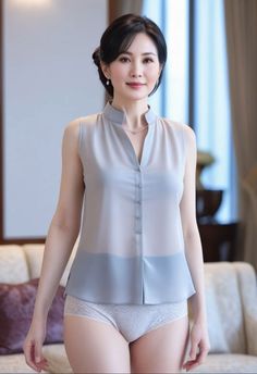 Woman in a sheer sleeveless top and lace underwear indoors