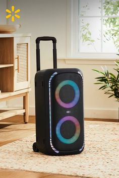 Portable speaker with RGB lighting in an indoor setting