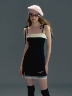 Woman in a black mini dress, pink beret, and sunglasses posing in a studio
