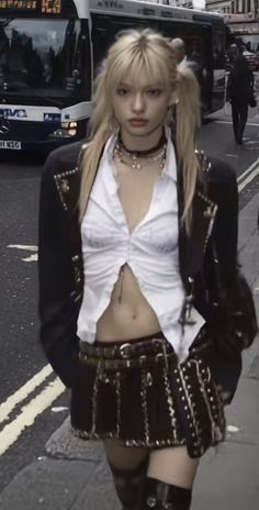 Blonde woman with pigtails in a mini skirt and open shirt on a street