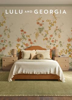 Bedroom with floral wallpaper, a bed, two nightstands, and a green rug