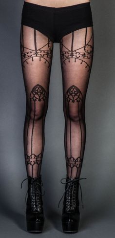 Person wearing black patterned tights and platform lace-up boots