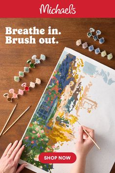 Overhead shot of a person painting a landscape with a paint by number kit