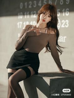 Woman in an off-shoulder top and mini skirt with thigh-high stockings posing outdoors