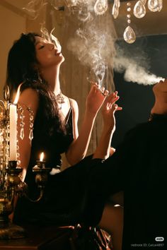 Two people smoking indoors with dramatic lighting and warm tones