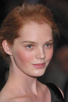 Woman with red hair and freckles in a close-up portrait