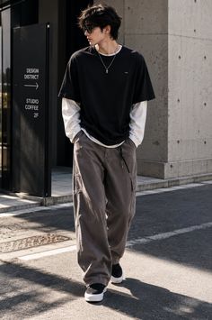Man in an oversized t-shirt and cargo pants walking on an urban street