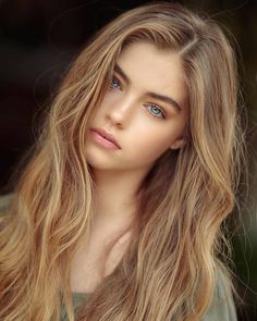 Young woman with long blonde hair and blue eyes looking at the viewer