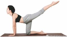 Woman in a sports bra and cropped pants performing a yoga pose