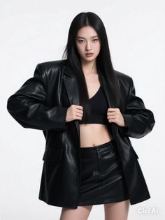 Woman in a black leather jacket and mini skirt with a crop top in a studio