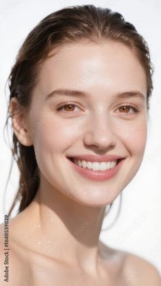 Woman with wet hair and bare shoulders smiling at the camera