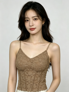 Woman with long dark hair wearing a brown lace top and small hoop earrings