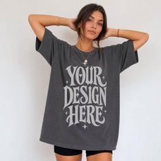 Woman in an oversized dark t-shirt and short shorts with hands behind her head