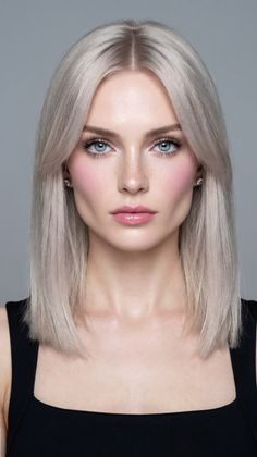 Woman with blonde hair and blue eyes wearing a black top
