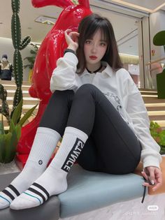Woman with long hair and red lips sitting indoors