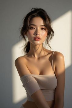 Woman with a ponytail in a spaghetti strap top with soft lighting