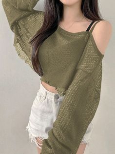 Woman in a green mesh crop top and white distressed shorts