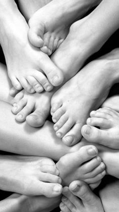 Close up of multiple intertwined feet in black and white