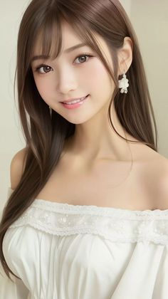 Woman with long brown hair wearing a white off-shoulder dress and earrings