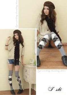 Woman in a beret, argyle socks, and denim shorts posing indoors