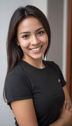 Smiling woman with long dark hair wearing a black t-shirt indoors