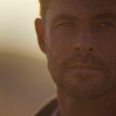Man with short hair and beard in warm golden hour light