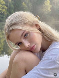 Blonde woman in a white t-shirt outdoors with soft lighting