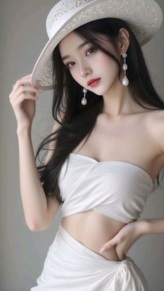 Woman in a white hat and top with exposed midriff and pearl earrings
