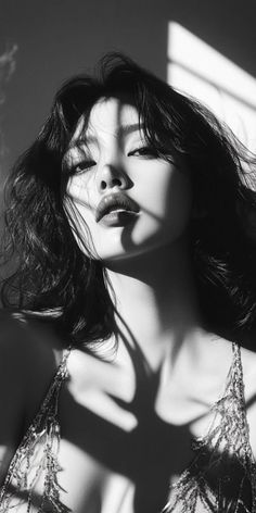 Woman with long hair in a dramatic black and white upper body shot