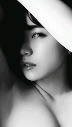 Close up black and white portrait with dramatic lighting and exposed skin