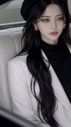 Woman with long black hair wearing a white blazer and black beret