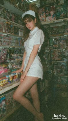 Woman in a nurse uniform posing in an indoor setting with film grain