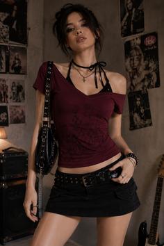 Woman in a dark red top and black mini skirt with rock-style accessories